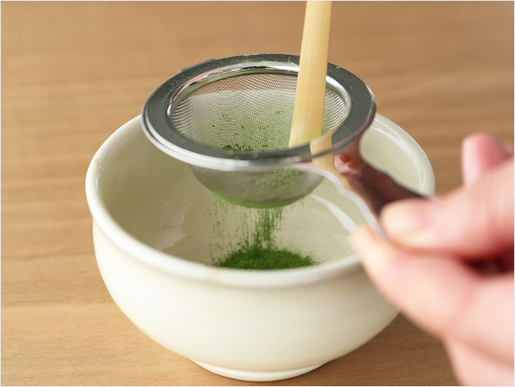 抹茶スティックを茶漉しに入れる様子